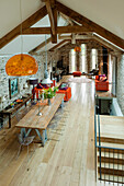 Rustic loft-style dining area with stone walls and wooden beams