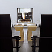 Modern living room with black armchairs and wooden side tables