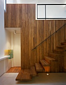 Staircase with wood-panelled wall