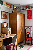 Room with desk, wooden cupboard and bookshelves