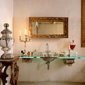 Bathroom with antique furniture and glass top with recessed washbasin