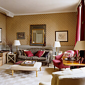 Living room with patterned wallpaper, mirror and red curtains