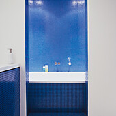 Bathroom with blue mosaic tiles and bathtub