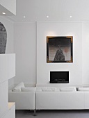 White living room with sofa & fireplace