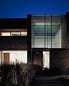 Entrance of contemporary house with slatted structure at dusk
