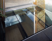 Glass element as source of light for lower storey