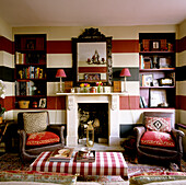 Living room with striped walls, chequered coffee table, mirror and bookshelves