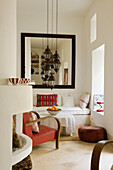 Cosy corner with built-in bench, hanging lanterns and red armchair