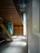 Contemporary foyer with wooden staircase