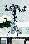 Candlestick with leaf motif on a garden table