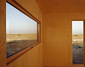 Wood-panelled room with views of landscape