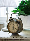 Old alarm clock on bedside table