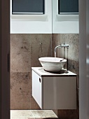 View of bathroom with water running into designer washbasin