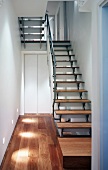 Stairwell with simple, modern staircase in wood and stainless steel