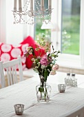 Flowers in glass vase on table