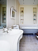 Renovated bathroom with vintage-style bathtub and sinks