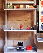 Decorative elements and Playmobil figures on an aluminium shelf