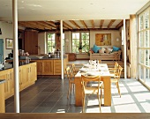 Sunny kitchen-dining room with raised living area in young, modern style