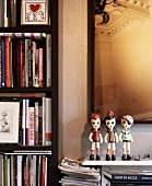Plastic figurines on shelf in front of picture