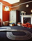 Toy racetrack on black carpet and coloured walls in child's bedroom