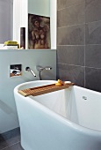 Detail of free-standing bathtub with designer, wall-mounted taps