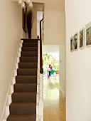 Traditional stairwell with view through open doorway into dining room