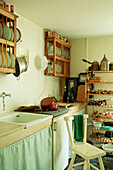 Small kitchen with wooden shelves and crockery