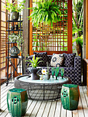 Terrasse mit Couch, Kaffeetisch und Keramikhocker