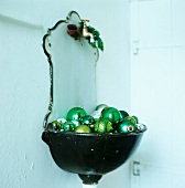 Fountain wall sink with green baubles