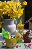 Easter sweets and daffodils on garden table