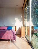 Bedroom with floor-to-ceiling glass wall