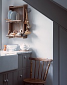 Detail of kitchen unit with vintage-style plate rack on wall