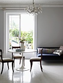 Living room with round table & chairs, sofa & chandelier
