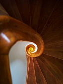 View of a spiral wooden staircase with spiral stairwell