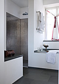 Contemporary designer bathroom with metallic mosaic tiles in shower area