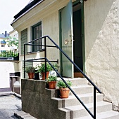 Stairs in front of a home with an open door