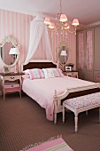 Baroque bedroom in pink with a canopy over the double bed