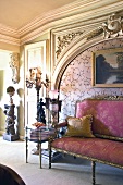 Bench with violet silk upholstery in front of carved, Rococo wall panel