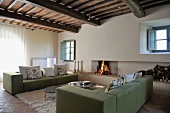 Cubist sofas in front of open fire in renovated country house
