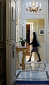 Woman walking through hallway in hotel
