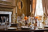 Festive table set with crockery and crystal wine glasses in grand room