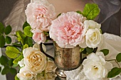 White and pink cut peonies in old brass pitcher