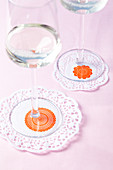 Doilies with stamp motifs used as coasters