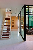 Staircase in open-plan foyer with view of glazed courtyard