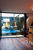 Modern interior with open terrace window and view of pool