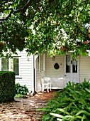 White, Scandinavian wooden house with garden
