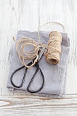 Scissors and twine on a grey cloth
