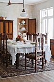 Dark wood, Spanish-style chairs at festively set table in traditional setting