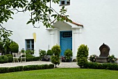 View of white house facade with blue front door