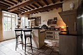 Rustic kitchen with island unit and bar stools